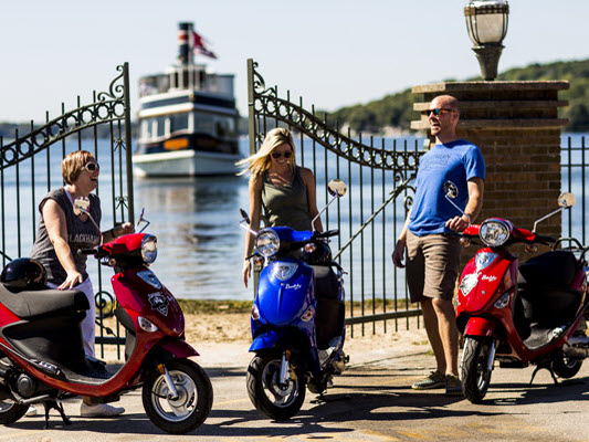 Guests enjoying scooters beside Geneva Lake